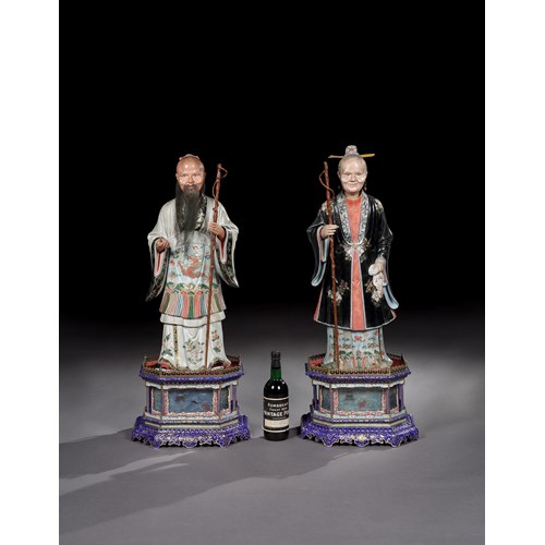 A pair of Chinese export polychrome decorated clay nodding figures